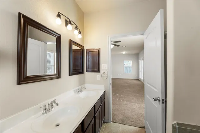 a bathroom with a granite countertop sink mirror and double