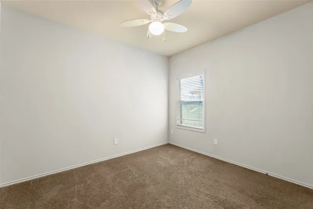 an empty room with a window and closet