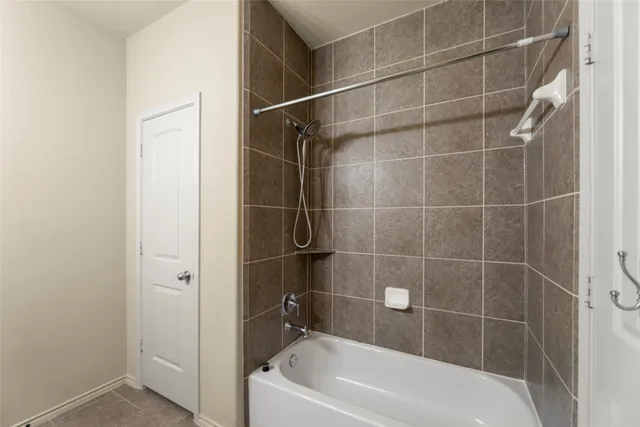 a bathroom with a bathtub and shower
