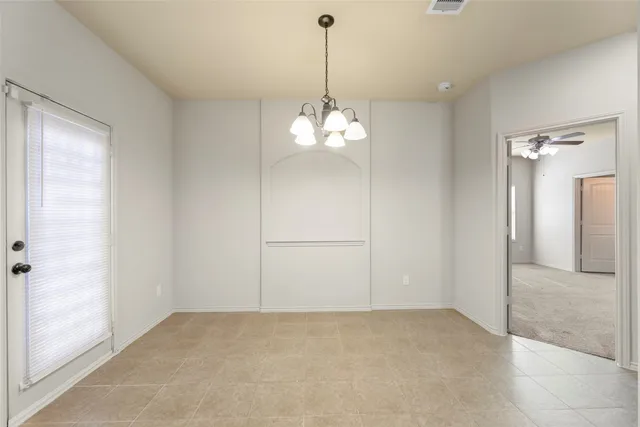 a view of a chandelier in big room and chandelier