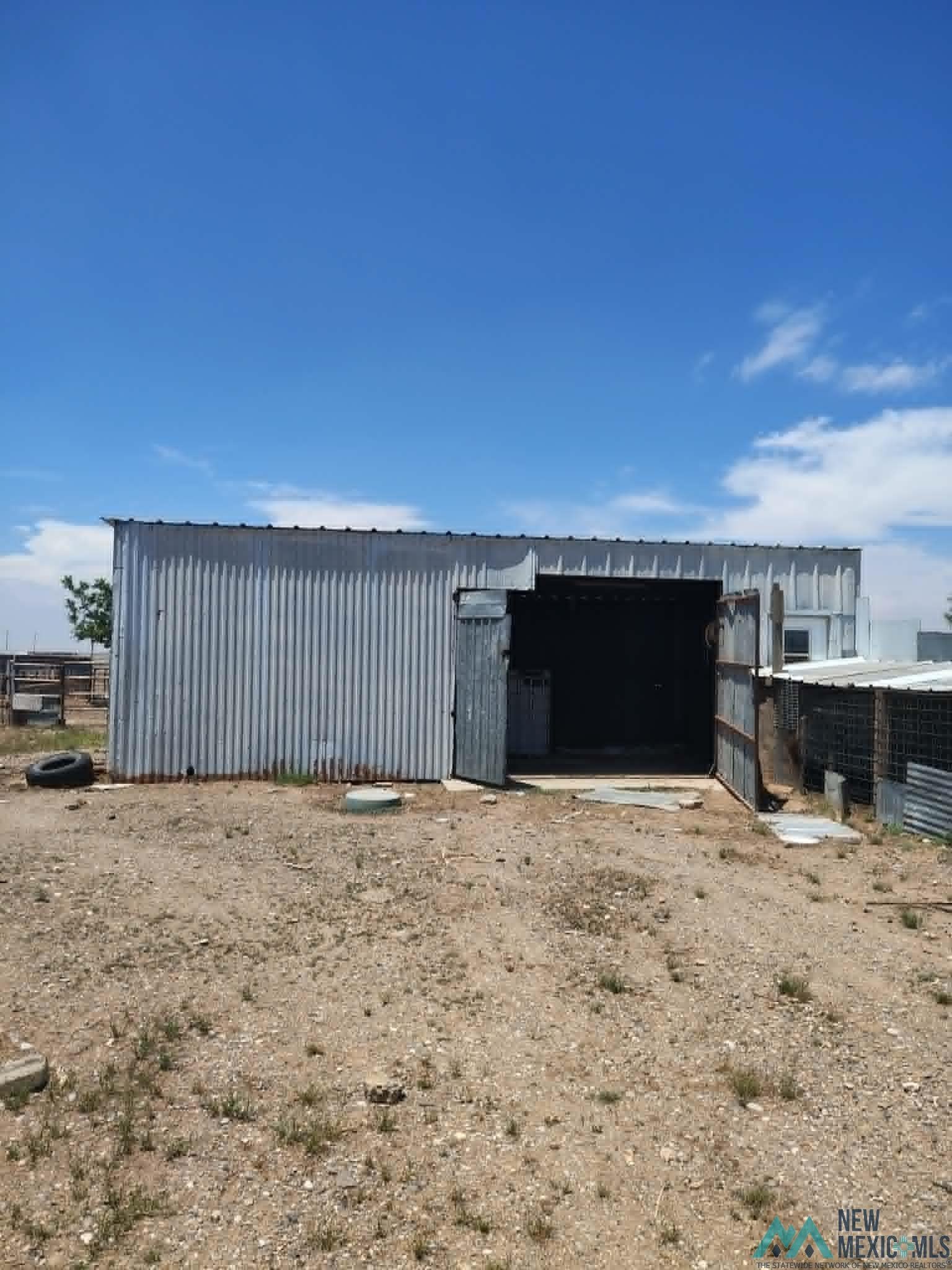 58 Fisk Road Dexter, NM 88230 - Photo 38 of 46 Metal utility structure featuring corrugated siding and a flat roof