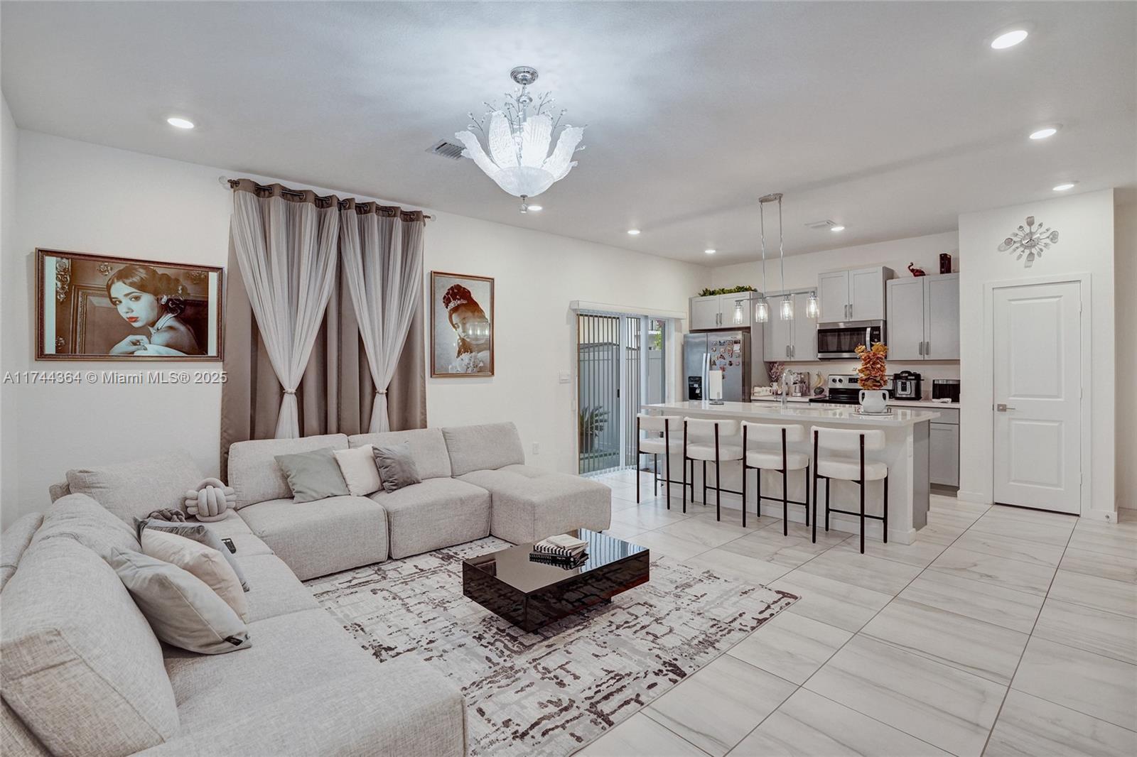 838 Southeast 17 Street Homestead, FL 33034 - Photo 17 of 66 a living room with furniture and a dining table with kitchen view
