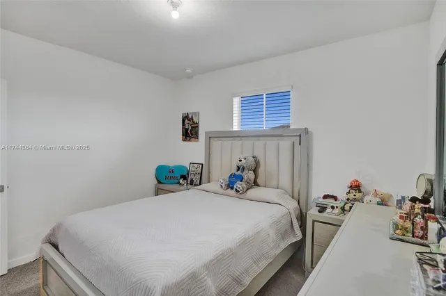 a bedroom with a bed and a table