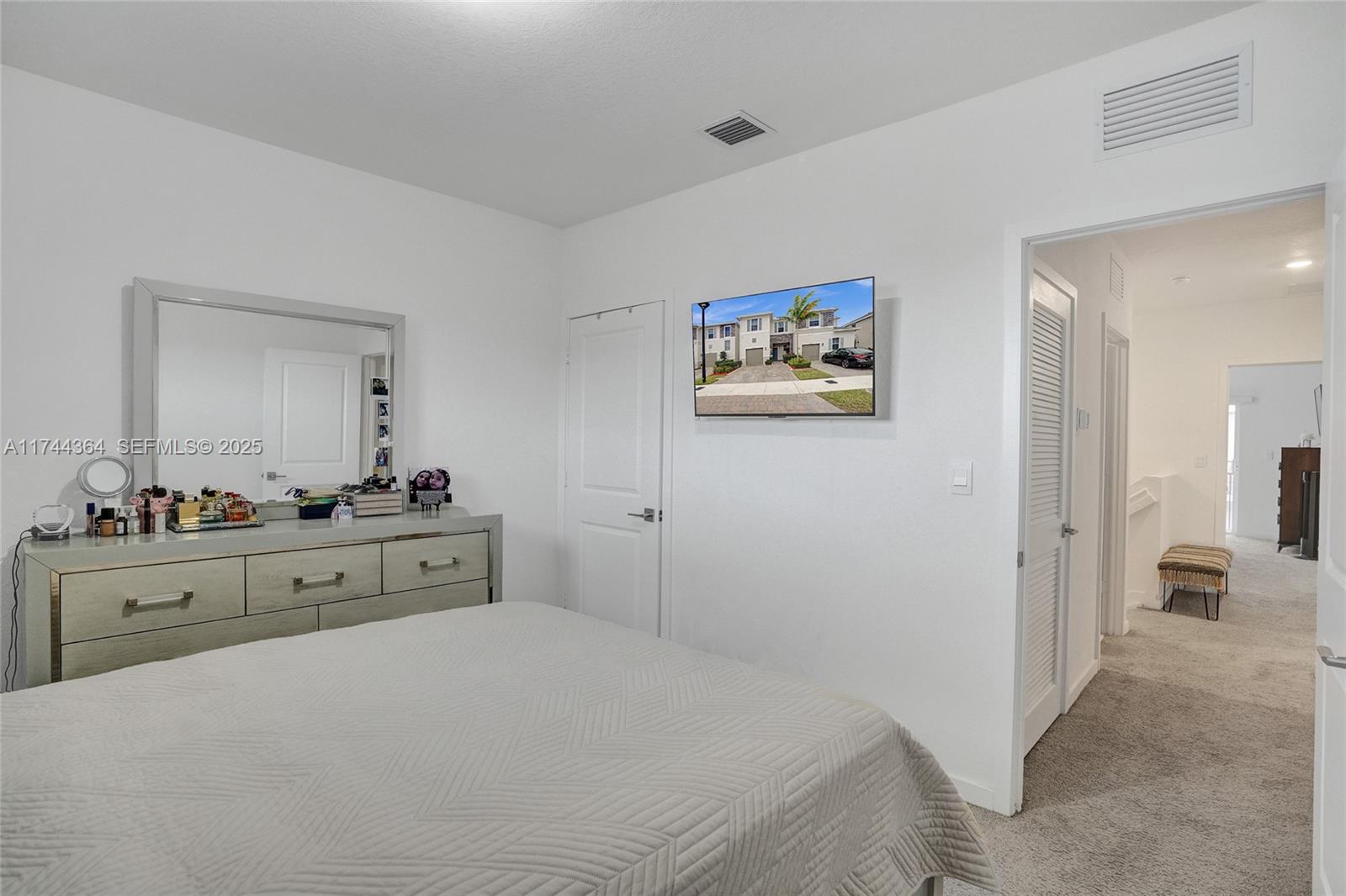 838 Southeast 17 Street Homestead, FL 33034 - Photo 22 of 66 a bedroom with a bed and a chandelier