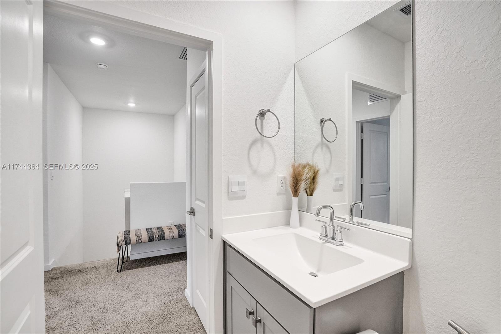 838 Southeast 17 Street Homestead, FL 33034 - Photo 28 of 66 a bathroom with a sink and a mirror