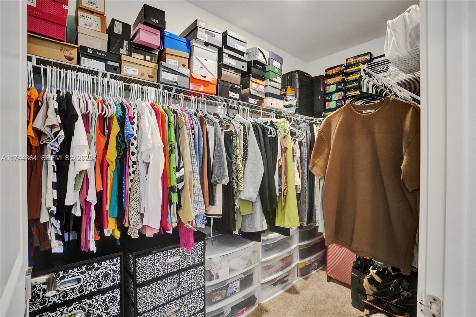 838 Southeast 17 Street Homestead, FL 33034 - Photo 39 of 66 a view of walk in closet with clothes
