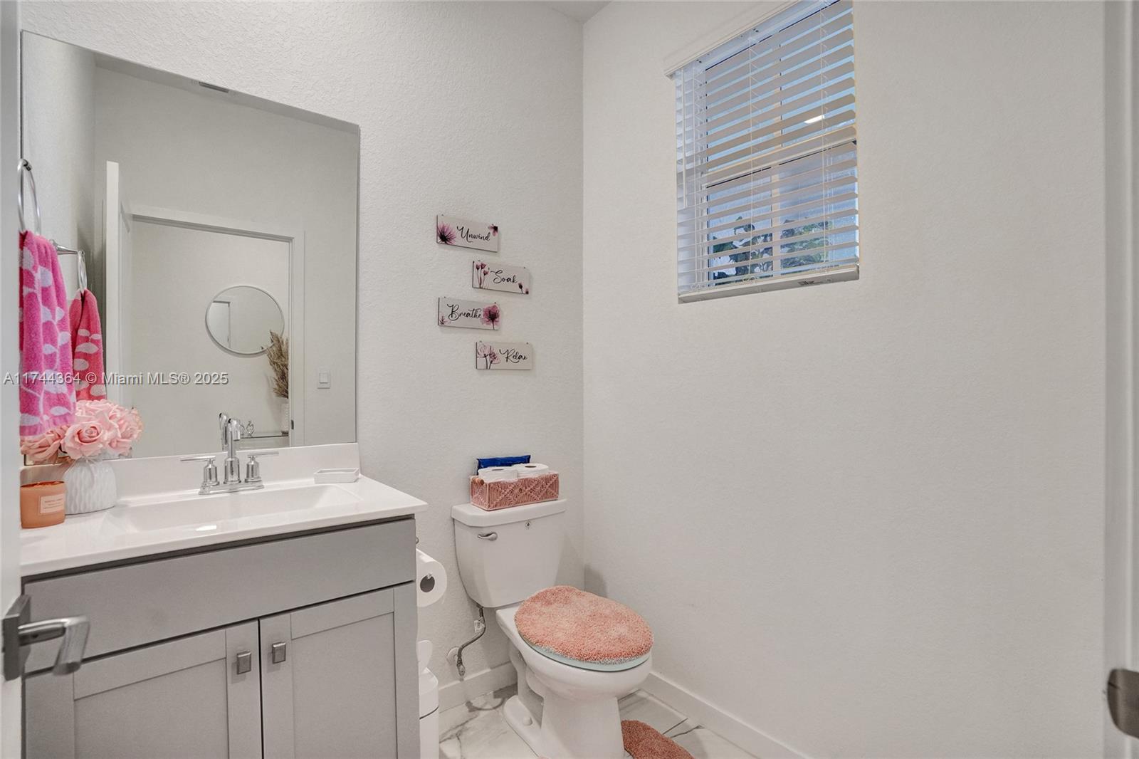 838 Southeast 17 Street Homestead, FL 33034 - Photo 41 of 66 a bathroom with a toilet sink vanity and mirror