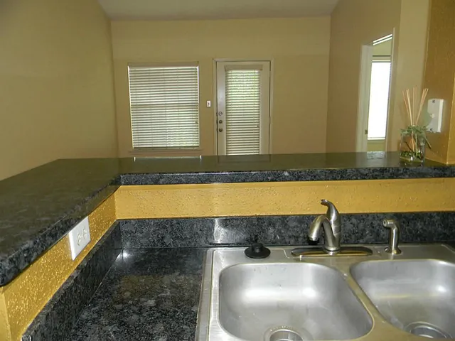 a bathroom with a granite countertop bathtub and sink
