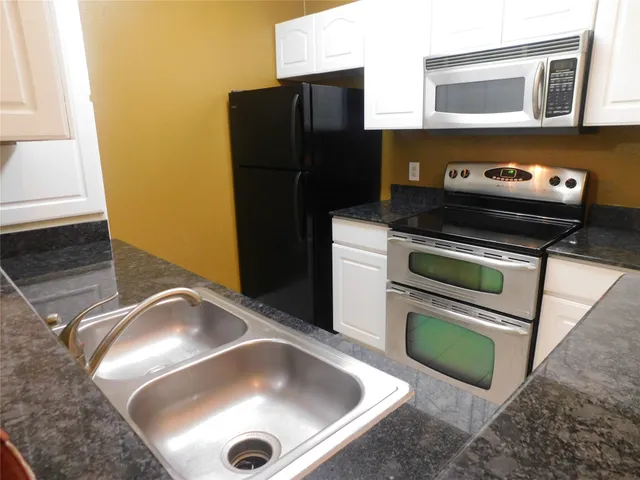 a kitchen with a sink and a refrigerator