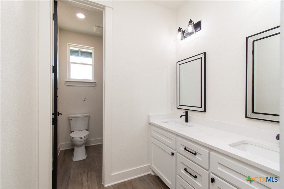 4245 Stringtown Road Temple, TX 76501 - Photo 19 of 25 a bathroom with a sink a toilet and a mirror