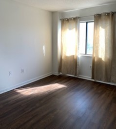 200 Sanders Ferry Road, Unit 1311 Hendersonville, TN 37075 - Photo 5 of 8 an empty room with wooden floor and windows