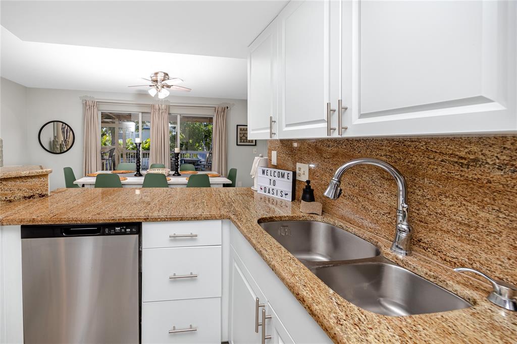 404 Maxwell Place Indian Rocks Beach, FL 33785 - Photo 14 of 66 a kitchen with a sink and a refrigerator