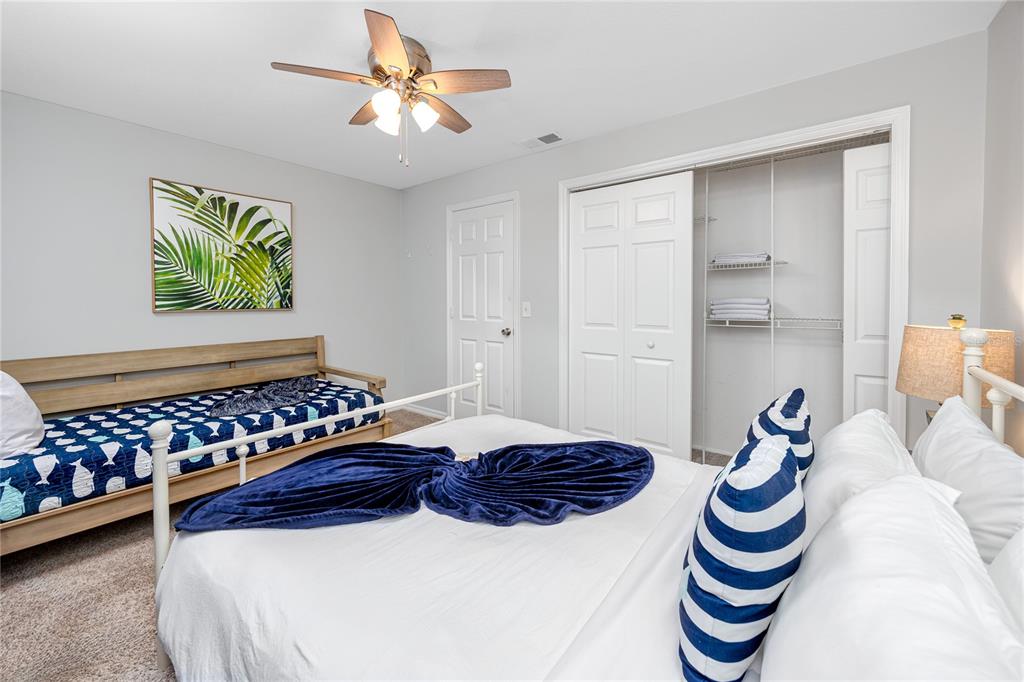 404 Maxwell Place Indian Rocks Beach, FL 33785 - Photo 22 of 66 a bedroom with a bed and a chandelier