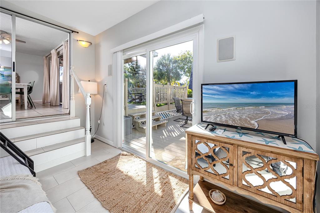 404 Maxwell Place Indian Rocks Beach, FL 33785 - Photo 26 of 66 a living room with furniture and a flat screen tv