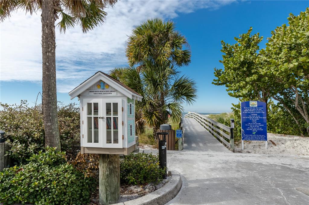 404 Maxwell Place Indian Rocks Beach, FL 33785 - Photo 44 of 66 a front view of a house with a yard and garage