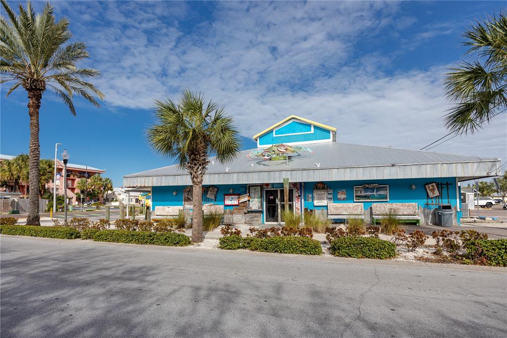 404 Maxwell Place Indian Rocks Beach, FL 33785 - Photo 55 of 66 a front view of a house with lots of trees