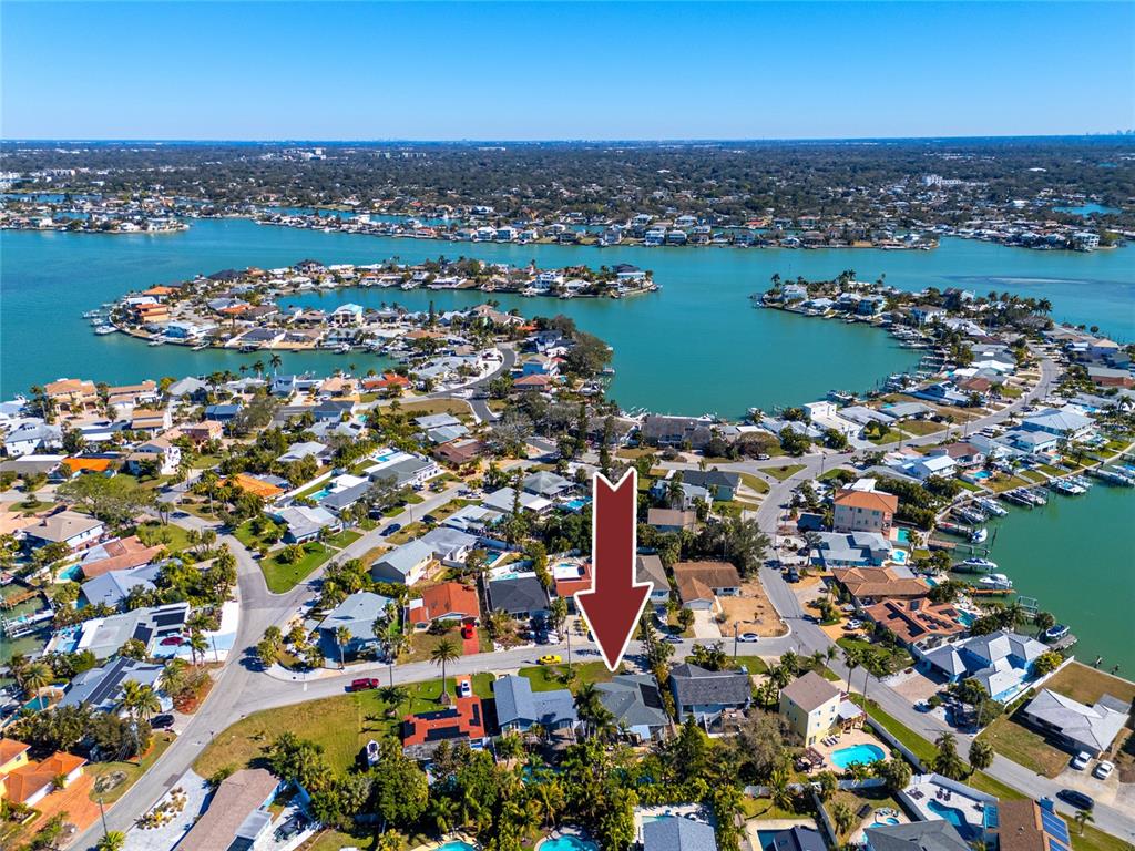 404 Maxwell Place Indian Rocks Beach, FL 33785 - Photo 60 of 66 an aerial view of a city with lots of residential buildings and ocean view in back