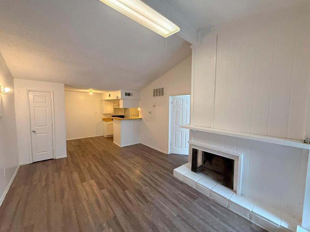 a kitchen with wooden floors and white appliances