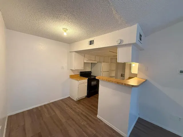 a kitchen with a sink and a stove top oven