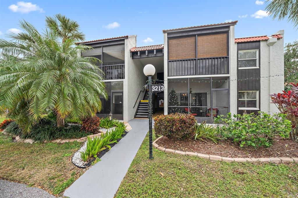 3213 South Beneva Road, Unit 201 Sarasota, FL 34232 - Photo 1 of 1 a front view of a house having yard
