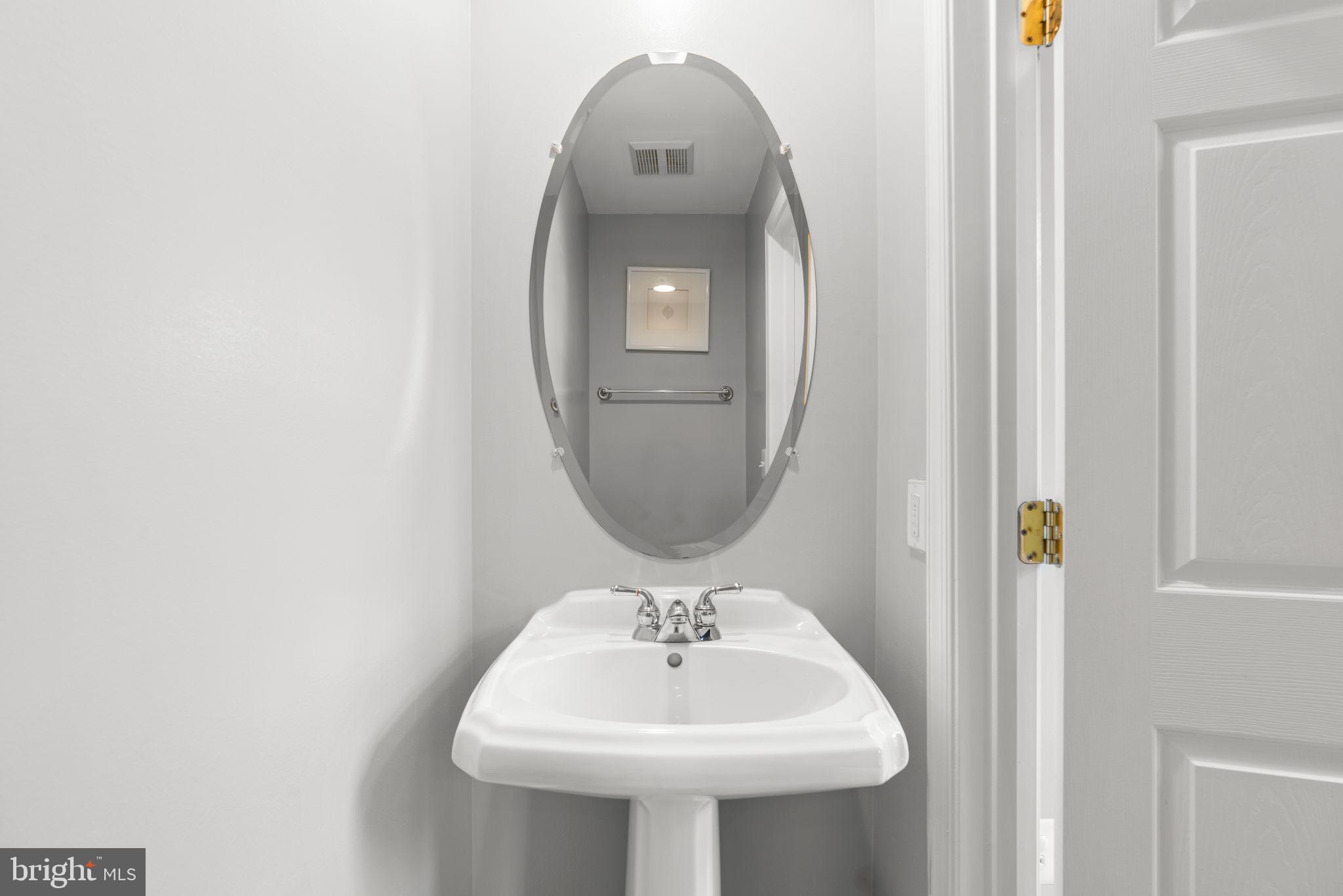 2475 Jostaberry Way Odenton, MD 21113 - Photo 19 of 53 a bathroom with a sink and a mirror