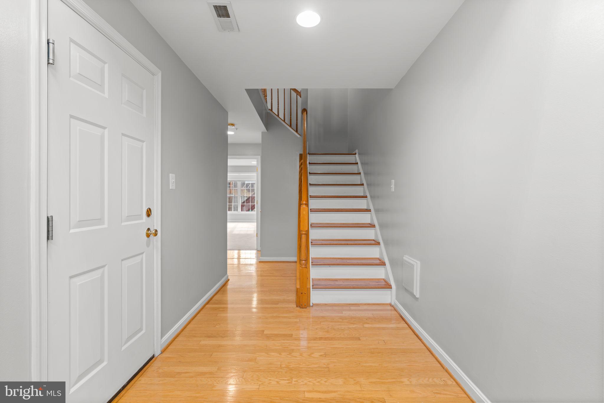 2475 Jostaberry Way Odenton, MD 21113 - Photo 2 of 53 a view of a hallway with wooden floor and entryway