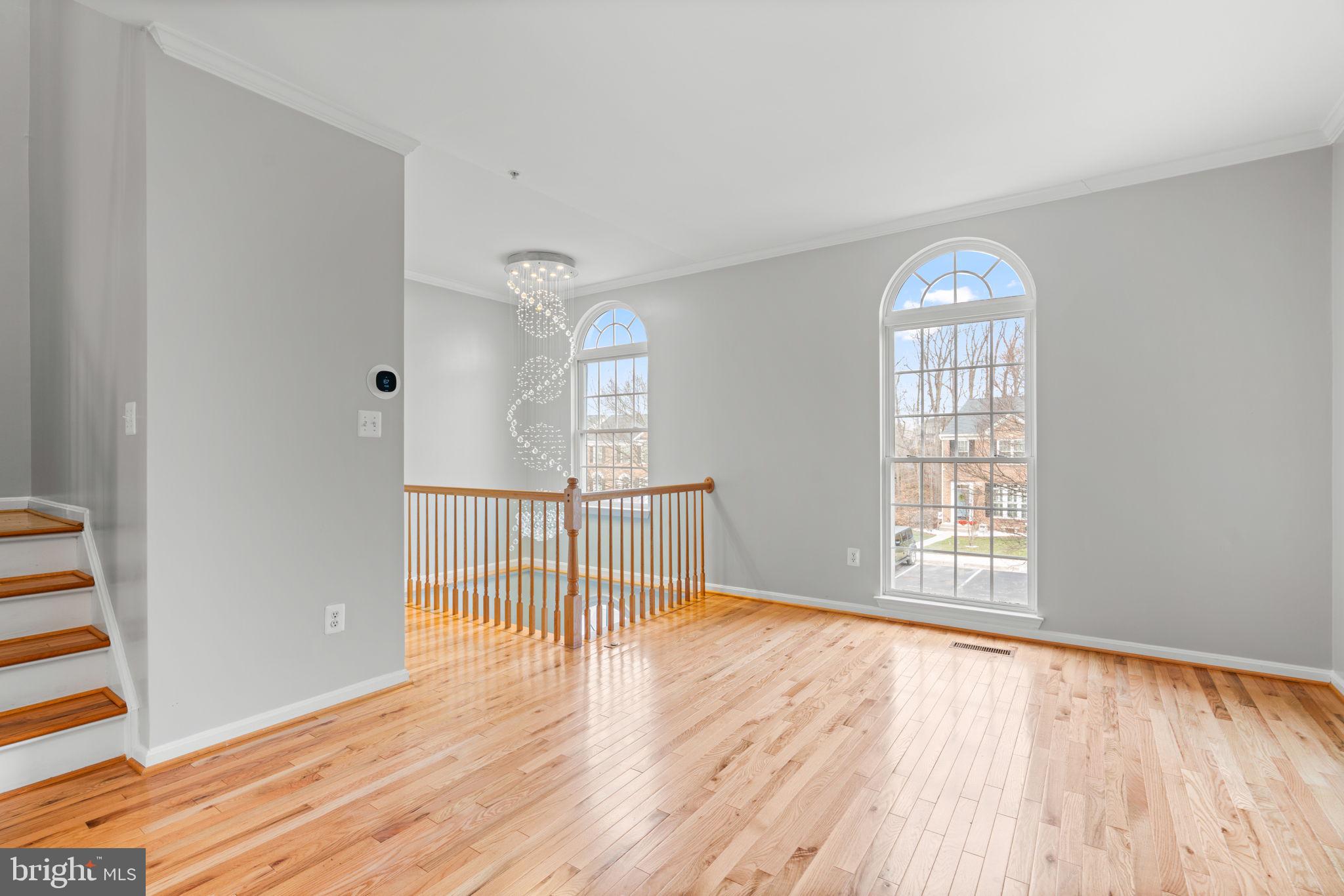 2475 Jostaberry Way Odenton, MD 21113 - Photo 3 of 53 a view of an empty room with wooden floor and a window