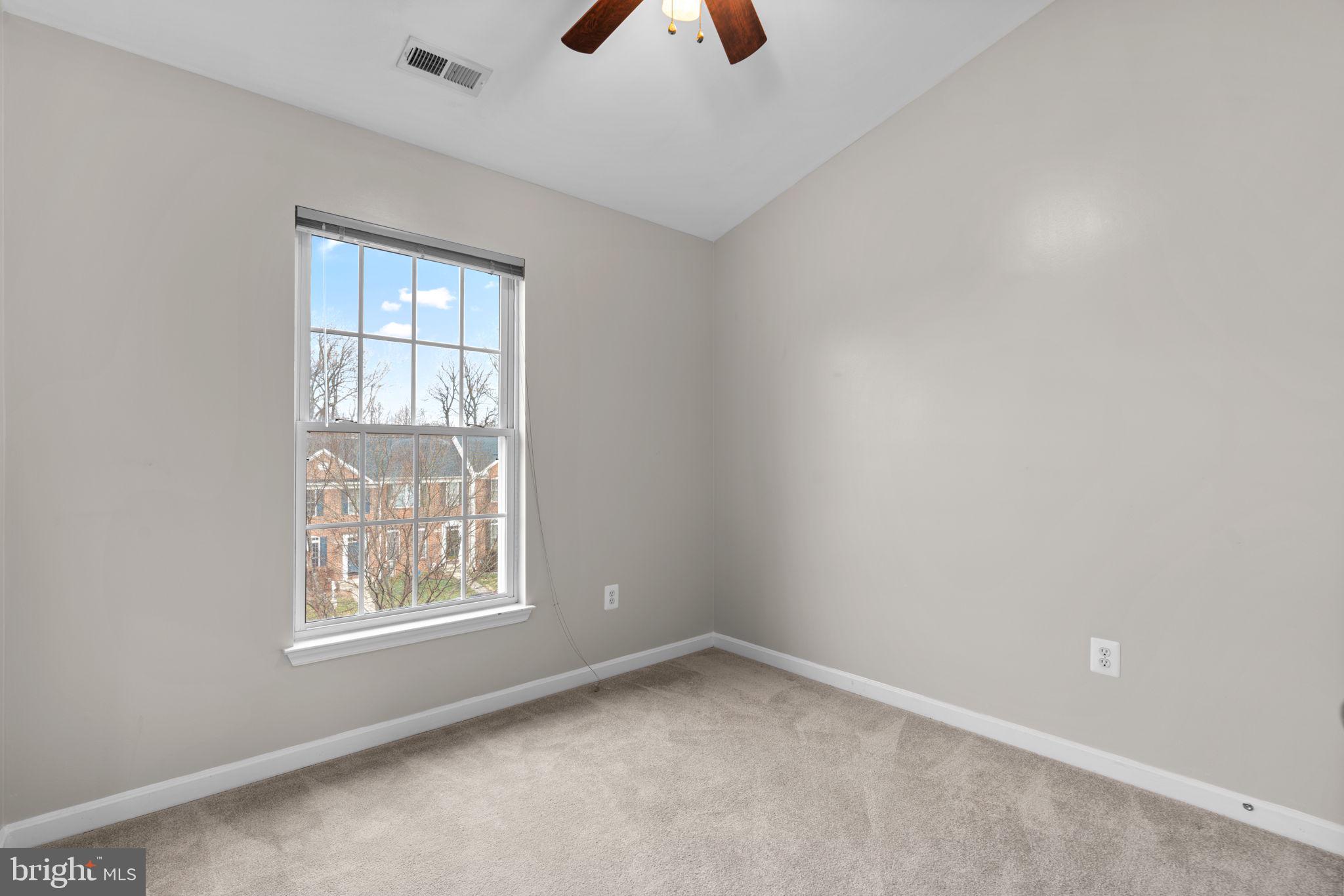 2475 Jostaberry Way Odenton, MD 21113 - Photo 32 of 53 an empty room with chandelier fan and windows