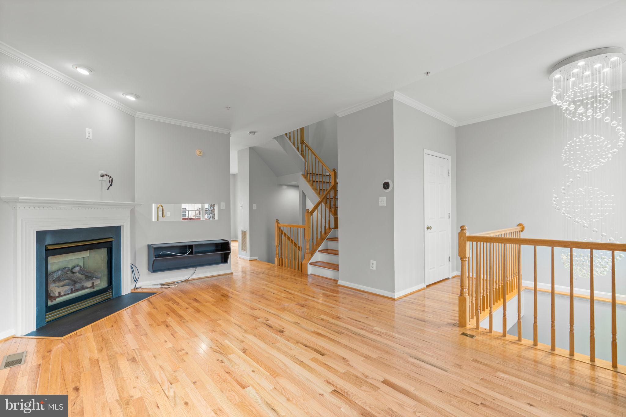 2475 Jostaberry Way Odenton, MD 21113 - Photo 4 of 53 a view of empty room with wooden floor and fireplace