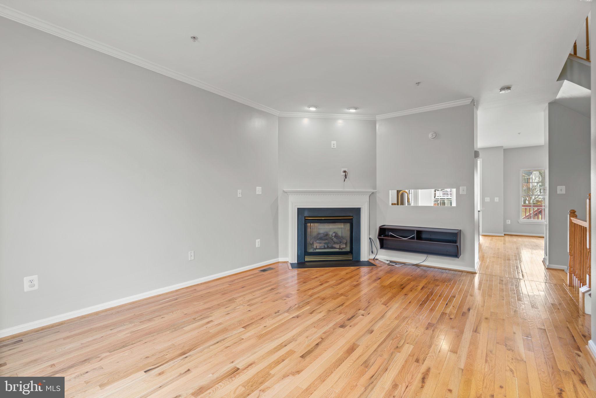 2475 Jostaberry Way Odenton, MD 21113 - Photo 5 of 53 a view of a livingroom with wooden floor and a fireplace