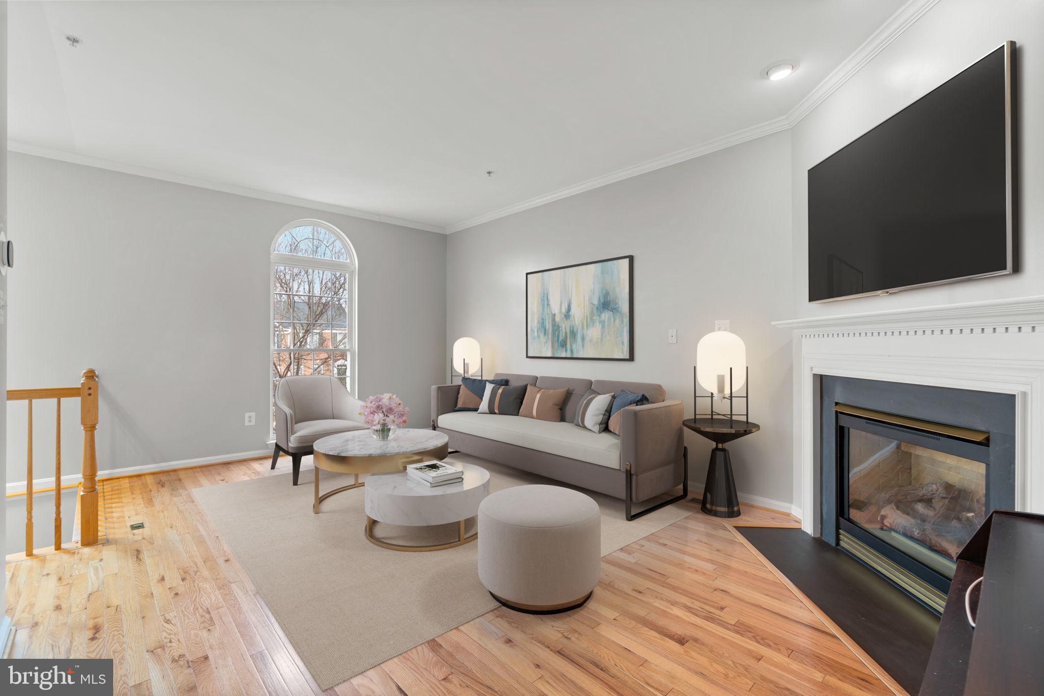 2475 Jostaberry Way Odenton, MD 21113 - Photo 7 of 53 a living room with furniture a flat screen tv and a fireplace