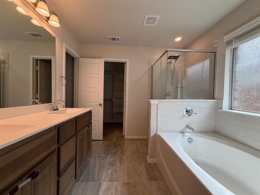 4420 Norcross Lane Crowley, TX 76036 - Photo 11 of 16 a bathroom with a tub sink and mirror