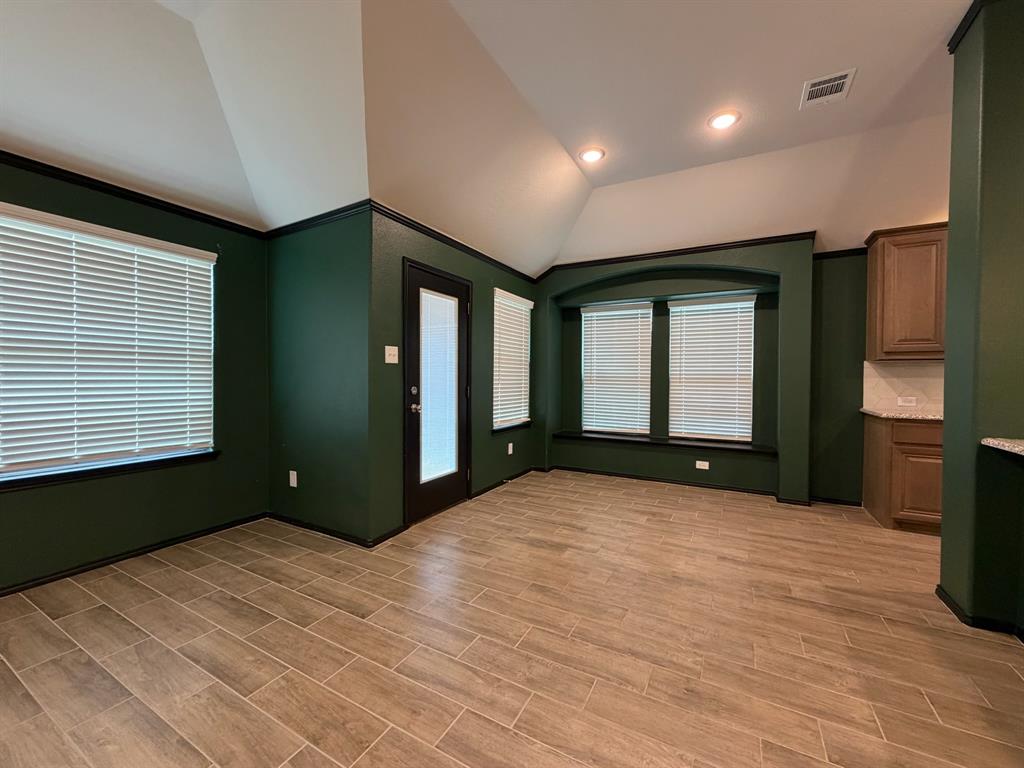 4420 Norcross Lane Crowley, TX 76036 - Photo 3 of 16 a view of an empty room with window and wooden floor