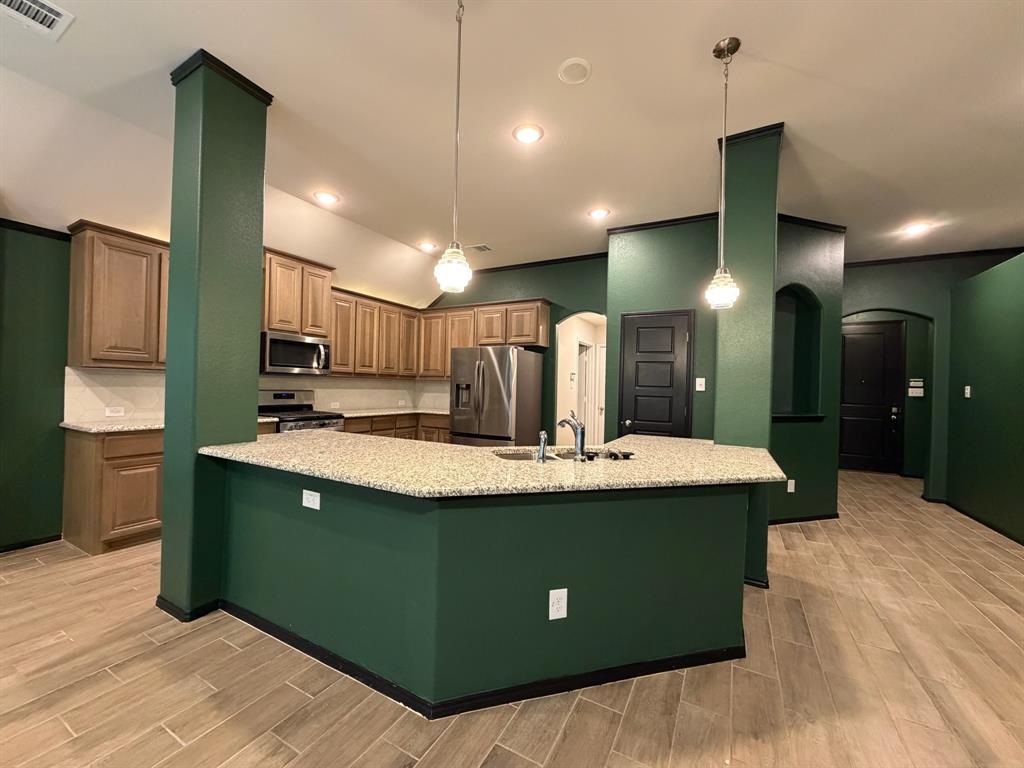 4420 Norcross Lane Crowley, TX 76036 - Photo 6 of 16 a view of kitchen with kitchen island a sink a stove and a refrigerator