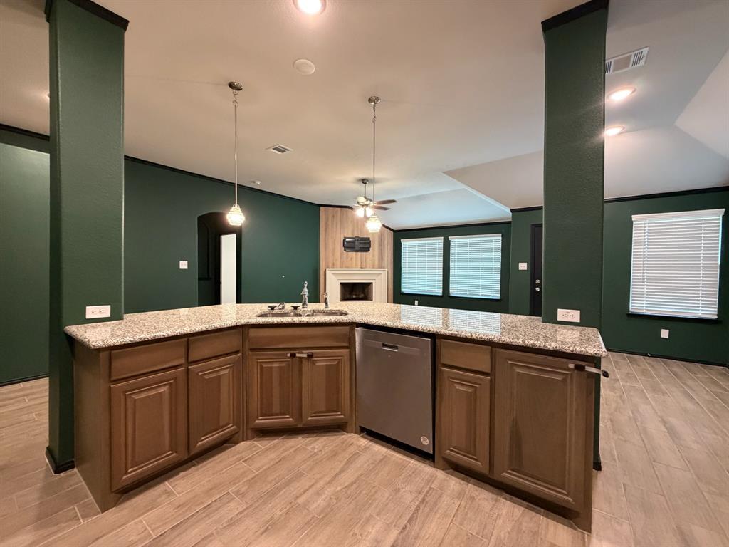 4420 Norcross Lane Crowley, TX 76036 - Photo 7 of 16 a kitchen with a sink cabinets and wooden floor