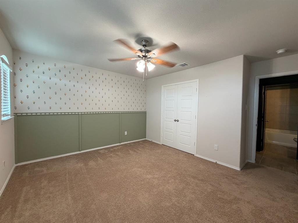 4420 Norcross Lane Crowley, TX 76036 - Photo 8 of 16 an empty room with closet and a chandelier fan