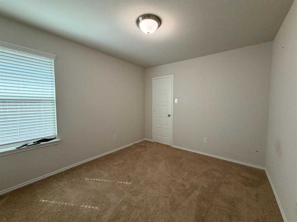 4420 Norcross Lane Crowley, TX 76036 - Photo 9 of 16 an empty room with a window