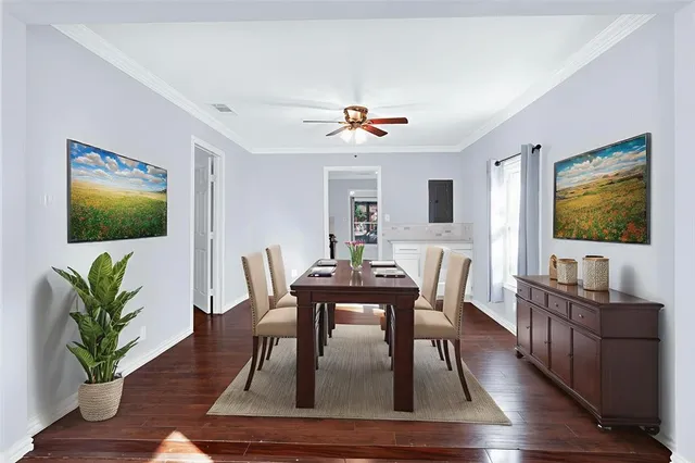 a dining room with furniture potted plant a fireplace and wooden floor