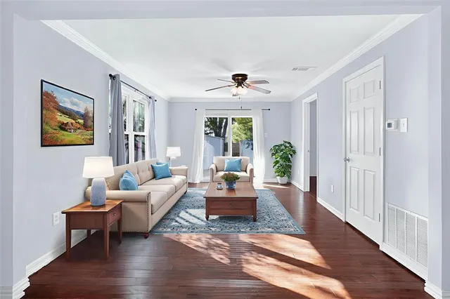 a living room with furniture and wooden floor