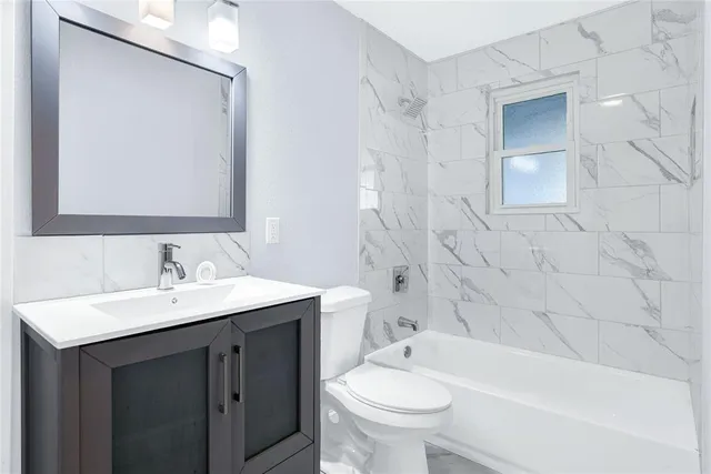 a bedroom with a large bed and a tv