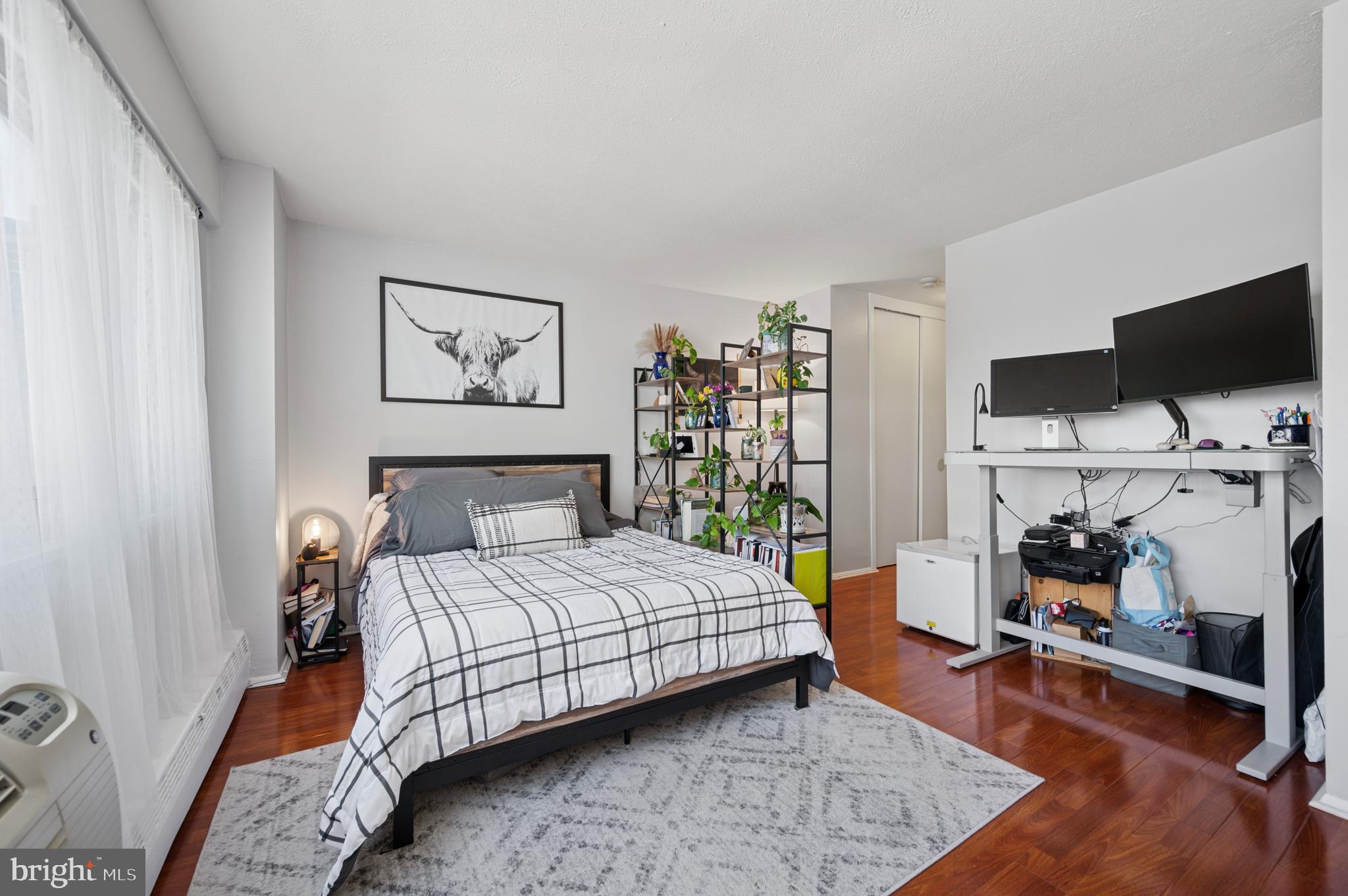 2101 Chestnut Street, Unit 1107 Philadelphia, PA 19103 - Photo 3 of 19 a bedroom with a bed a flat screen tv and a window