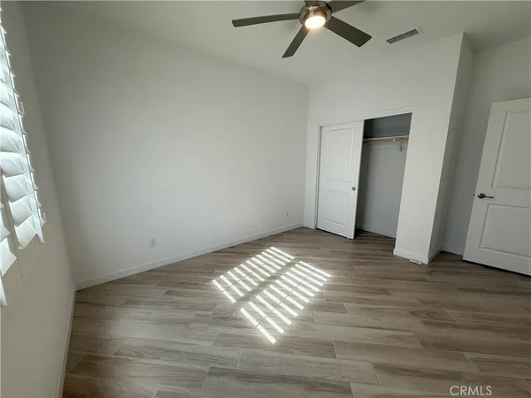 a view of an empty room and wooden floor