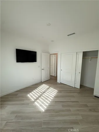 a view of a livingroom with wooden floor and closet