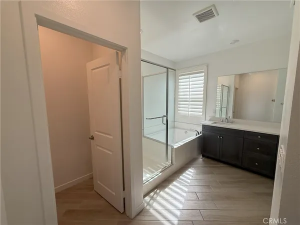 a bathroom with a double vanity sink and mirror with shower