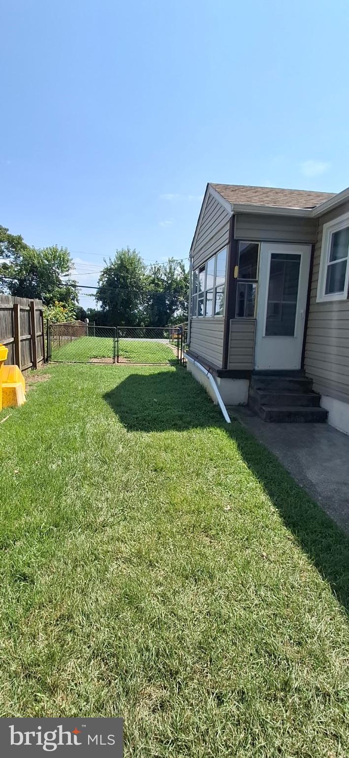 202 Holy Cross Road Brooklyn, MD 21225 - Photo 3 of 18 Sunny backyard retreat with lush grass.