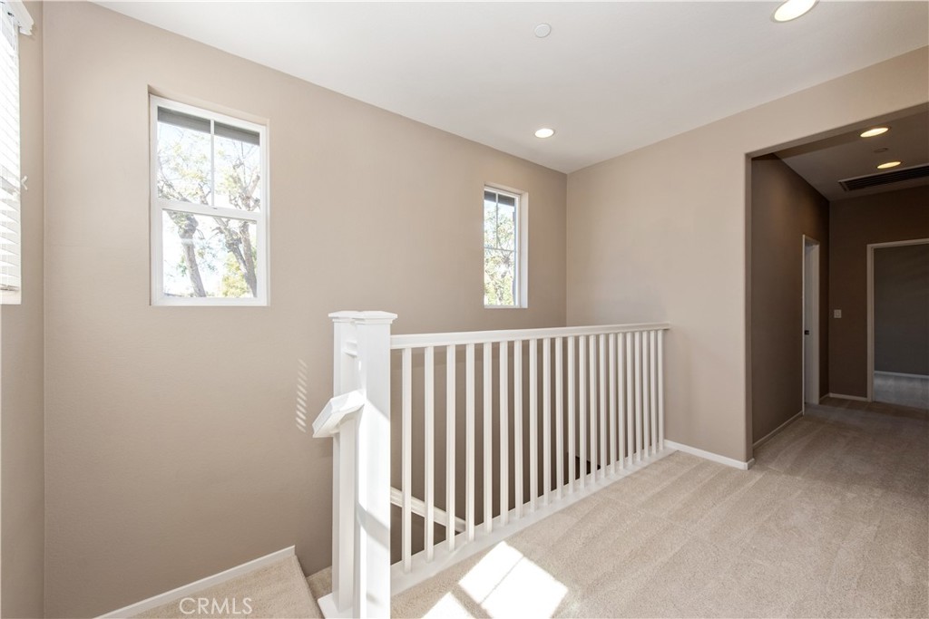 148 Compass Irvine, CA 92618 - Photo 13 of 26 a view of a hallway with windows