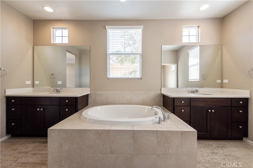 148 Compass Irvine, CA 92618 - Photo 18 of 26 a bath room with a sink vanity and mirror