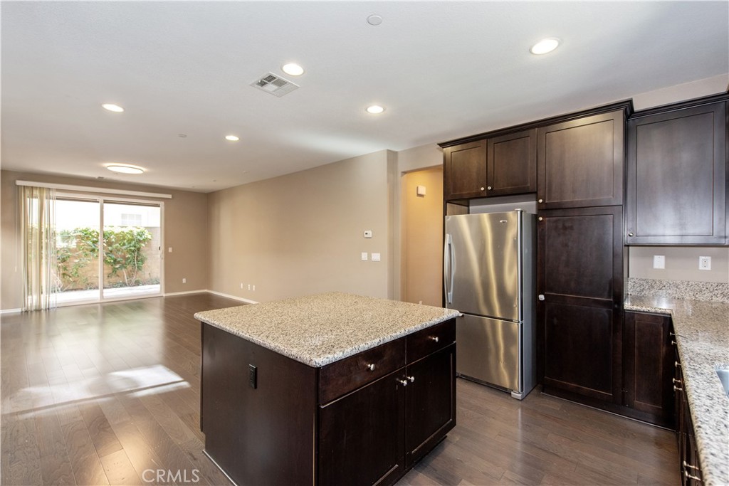 148 Compass Irvine, CA 92618 - Photo 7 of 26 a kitchen with kitchen island a counter top space refrigerator and a window