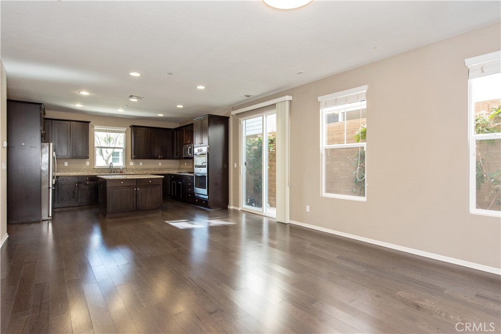 148 Compass Irvine, CA 92618 - Photo 10 of 26 a view of kitchen with refrigerator stove and wooden floor