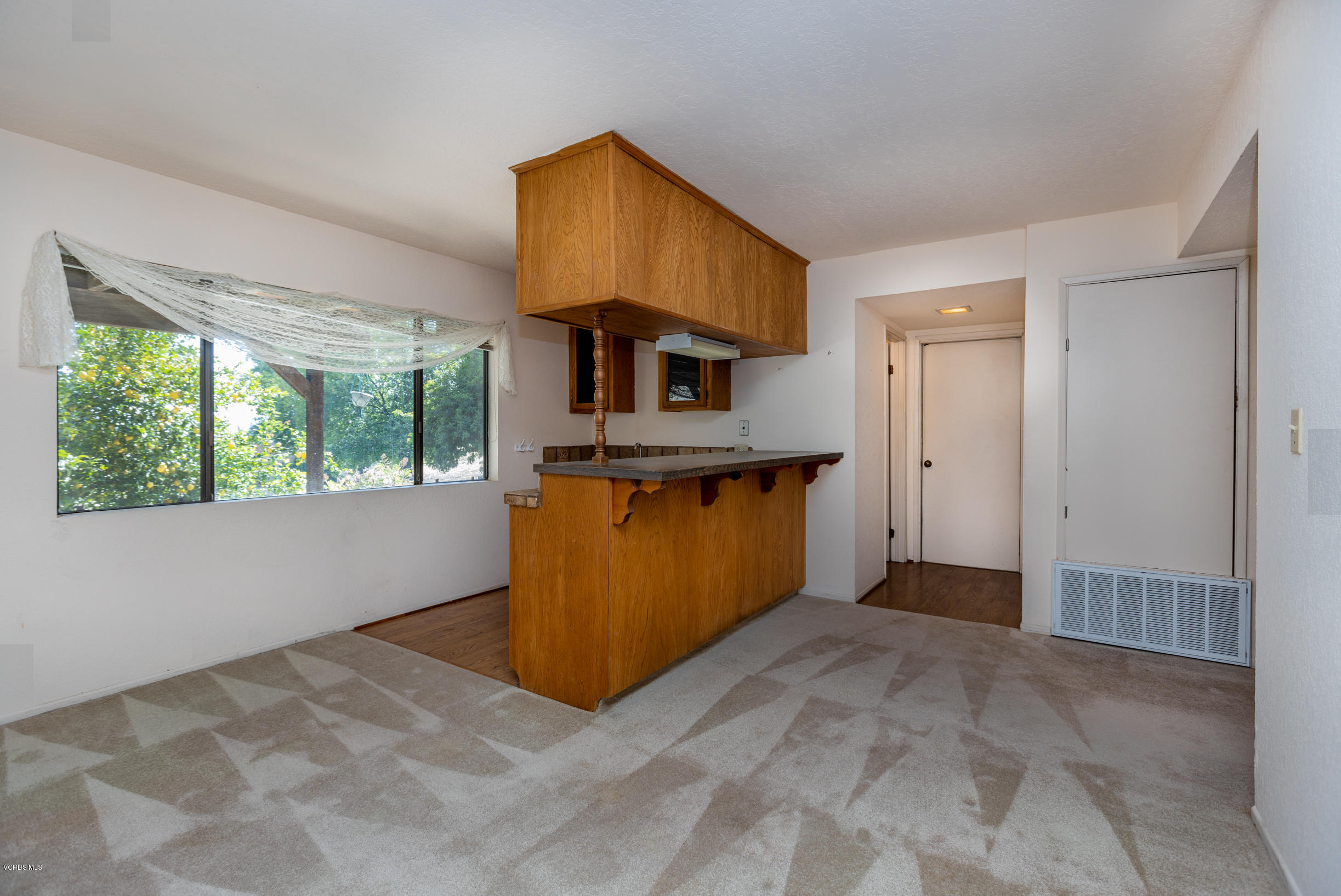 7240 Studio Road Canoga Park, CA 91304 - Photo 12 of 19 a view of a kitchen with a sink cabinets and a floor to ceiling window